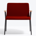 Generously sized chair with Ø20mm tubular steel frame, ash wood armrests, upholstered in fabric, leather or synthetic leather.