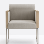 Armchair that combines oak details with a fabric or leather upholstered back.