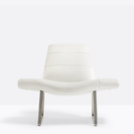 An armchair characterized by a soft upholstered seat in leather.